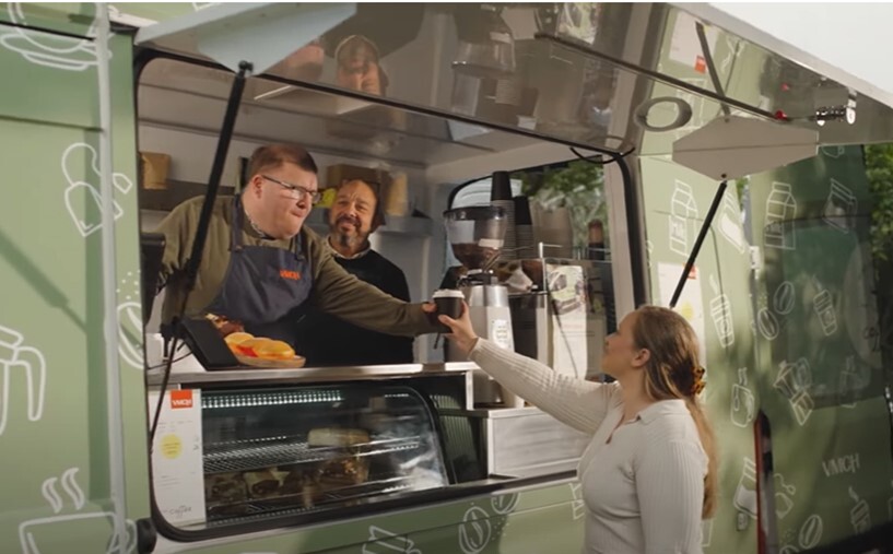 VMCH Coffee Van two men in the van one serving a female person a coffee